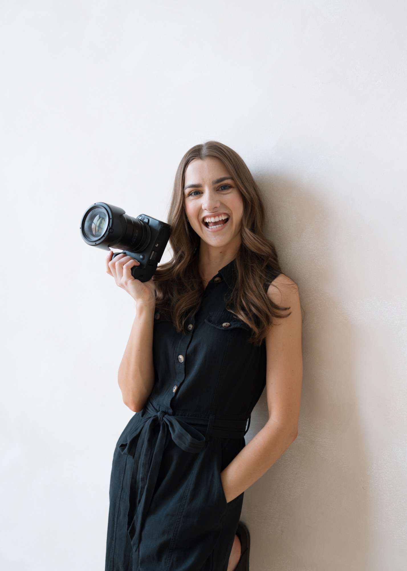 Summer Lecas, Chicago-based photographer and content creator, holding a camera