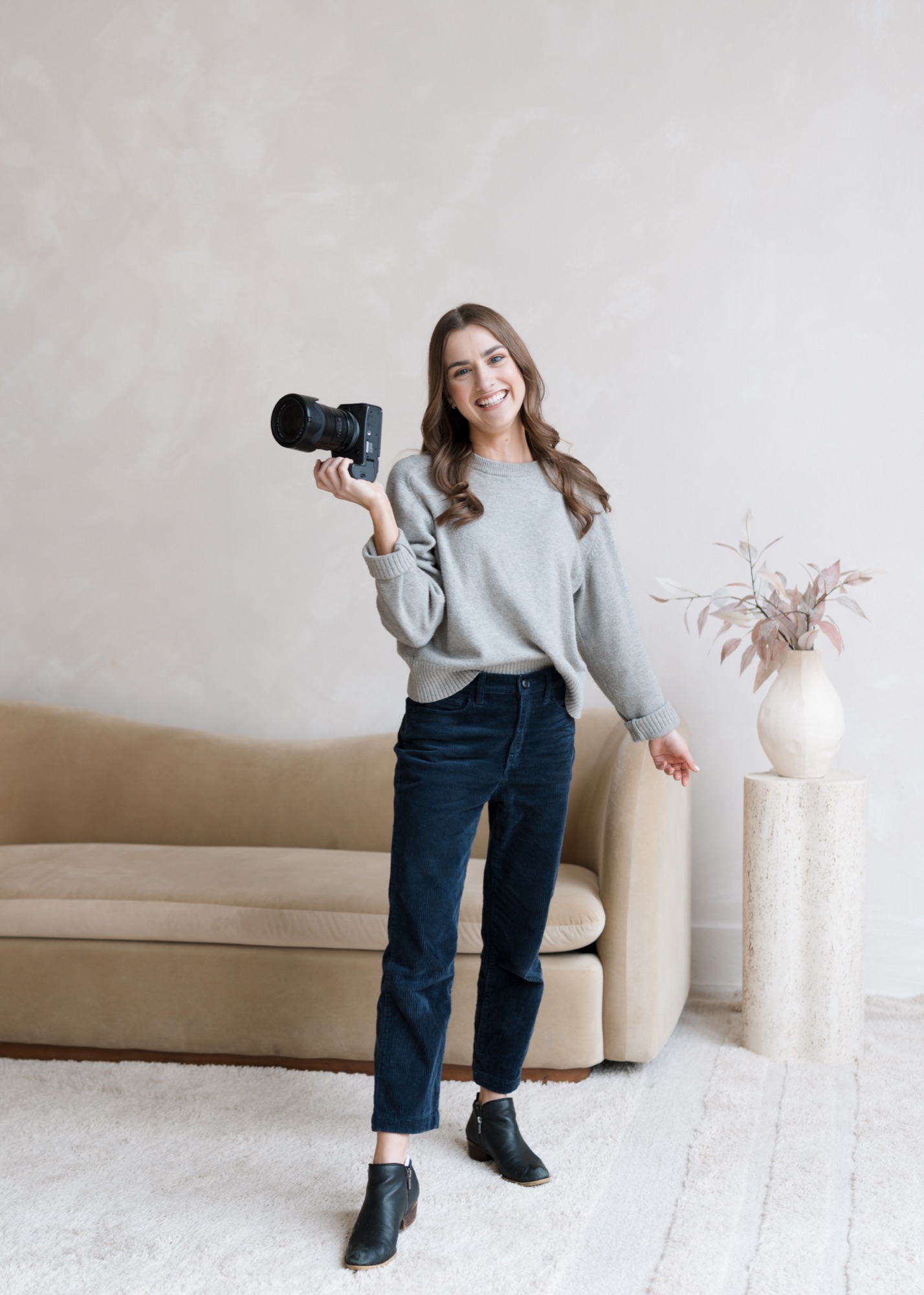 Summer Lecas smiling while holding a camera